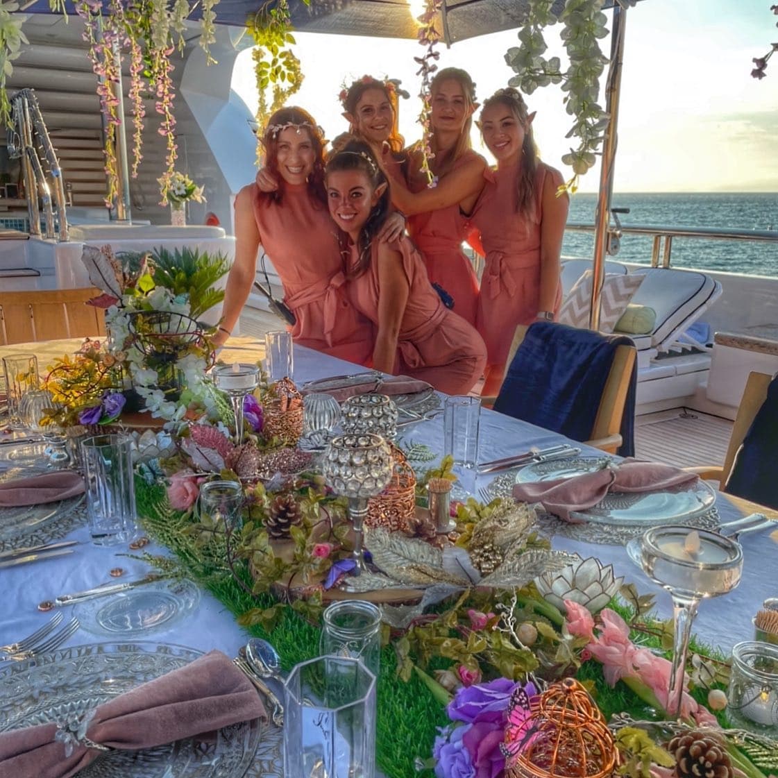 Crew in matching outfits at a themed dinner they styled and served
